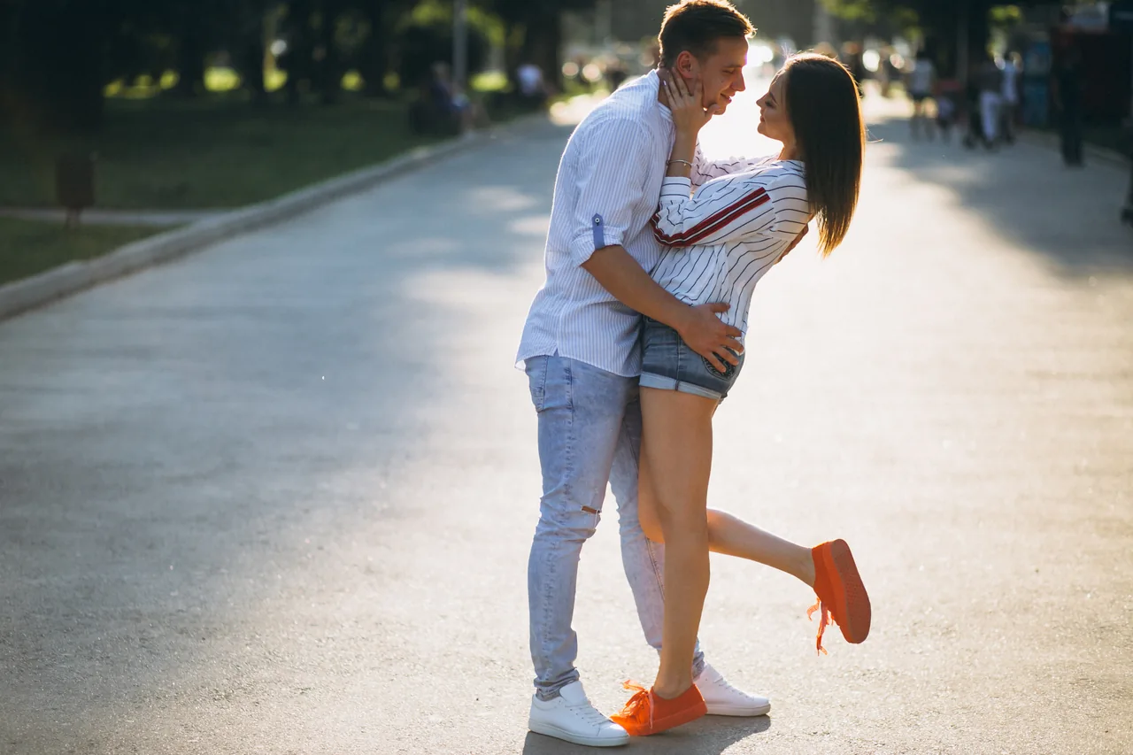 A couple embracing on a park path, illustrating Find Herpes Singles by Location and Distance