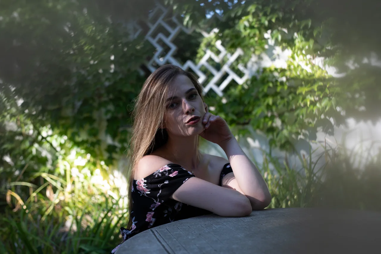 An adult sitting in a shaded garden, illustrating Herpes Dating Without Labels: Keep the Meaning Clear
