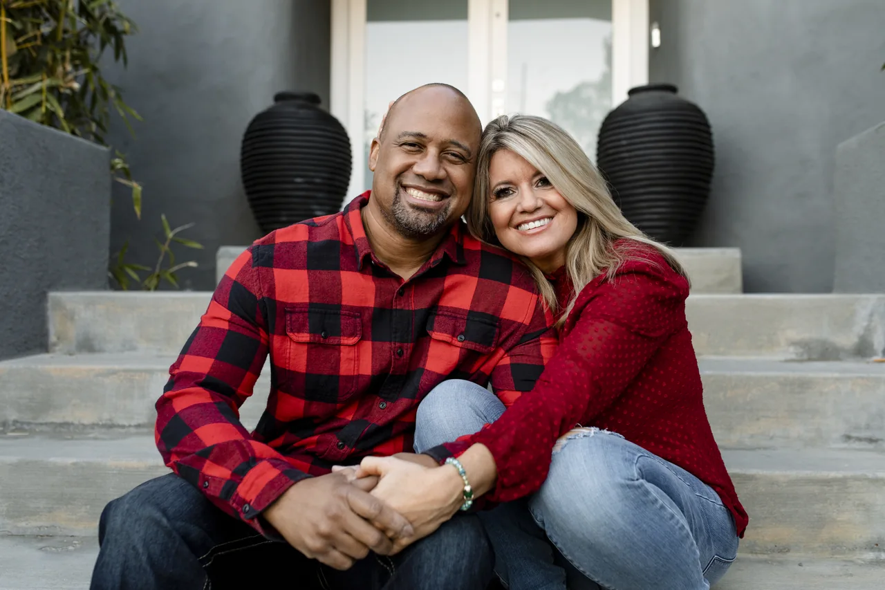 Two adults holding hands on a porch, illustrating Suburban Herpes Singles with Time to Meet Locally