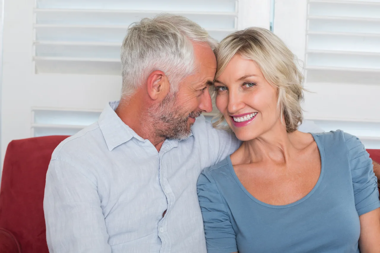 A mature couple relaxing on a couch, illustrating Herpes Dating Stories: Different Ways to Connect