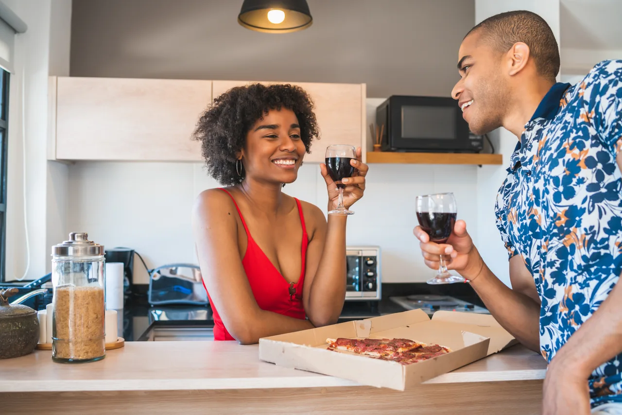 Two adults enjoying time together in a kitchen, illustrating Friends with Benefits and Herpes: Protect the Friendship