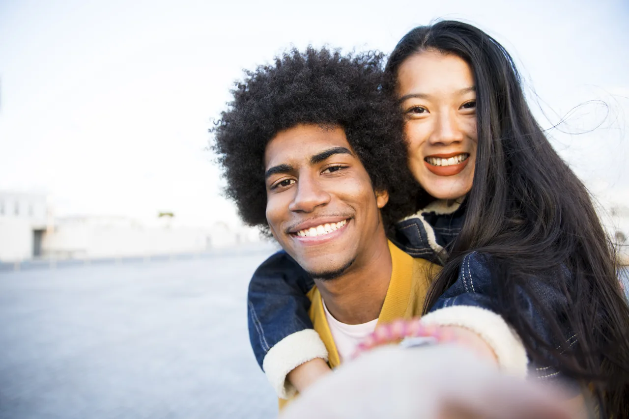 Two smiling adults beside a marina, illustrating HSV Singles and Dating Choices: Find Your Direction
